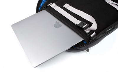 detail visible^^A laptop being removed from the laptop compartment via the zippered opening in the main compartment of the Synik 30. 
