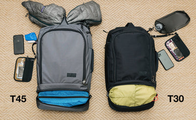visible detail ^^ A comparison of what can fit in the Techonauts. The Techonaut 45 (left) has a puffy coat stowed in the top grab handle and a Packing Cube in it's bottom pocket. The Techonaut 30 (right) has a Aeronaut 30 Travel Stuff Sack in its bottom pocket.