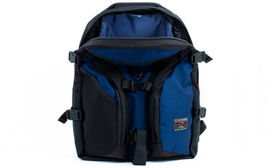 visible variant TB0104-DKDJ TB0114-DKDJ^^The Brain Bag in Deep Blue (dark blue) 525 Ballistic with the front main compartment zipper opened to reveal its Dawn (blue-grey) 210 Ballistic interior.