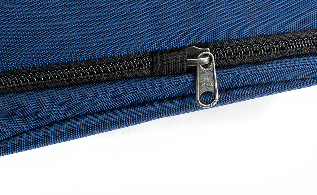 detail visible^^A close shot of point where the small side pocket zipper and main compartment zipper meet.