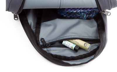 detail visible^^A chapstick and vial of perfume in the top interior zippered pocket.