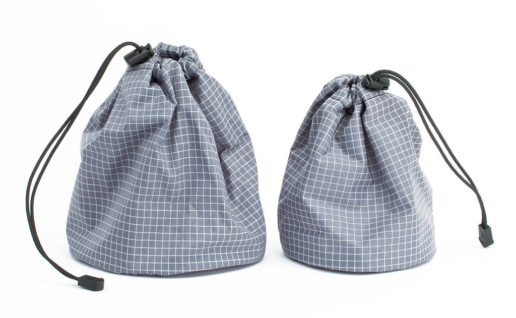 ^^A medium yarn stuff sack on the left and a small on the right, both Northwest Sky (light grey) 200 Halcyon in color and material respectively.