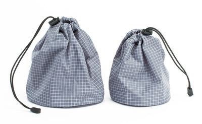 ^^A medium yarn stuff sack on the left and a small on the right, both Northwest Sky (light grey) 200 Halcyon in color and material respectively.