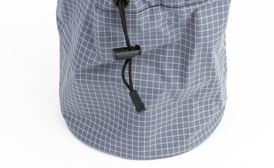 visible detail^^The pull string and compressing closure clip of the Yarn Stuff Sack, this one in Northwest Sky (light grey with white grid) 200 Halcyon.