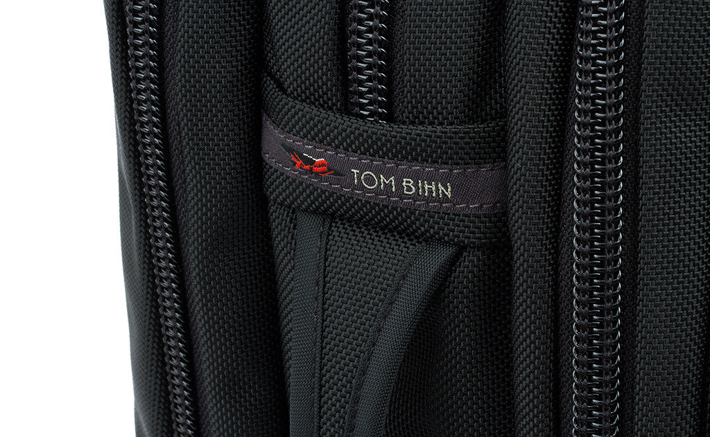 detail visible^^A close shot of the side grab handle and the TOM BIHN tag.