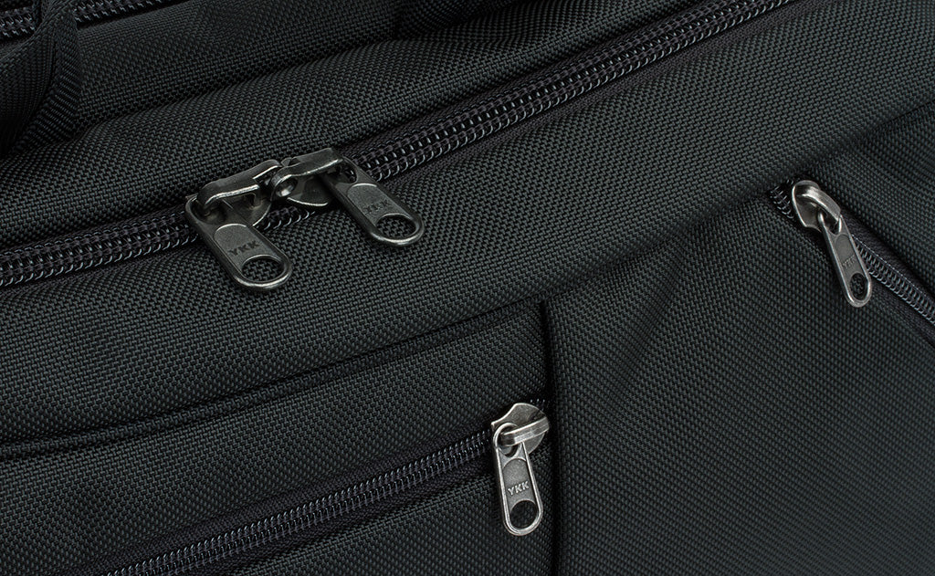 detail visible^^A close shot of the regular zippers of the front pockets and locking zippers on the main compartment of the Western Flyer.