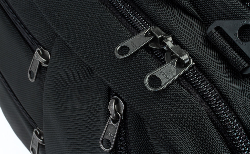 detail visible^^A close shot of the regular zippers of the front pockets and locking zippers on the main compartment of the Western Flyer.