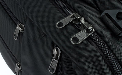 detail visible^^A close shot of the regular zippers of the front pockets and locking zippers on the main compartment of the Western Flyer.