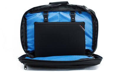detail visible^^The rear main pocket of a Black 525 Ballistic exterior Western Flyer opened to reveal an Island (blue) 200 Halcyon interior with a Cache connected to the nylon loops sewn into the interior seam.
