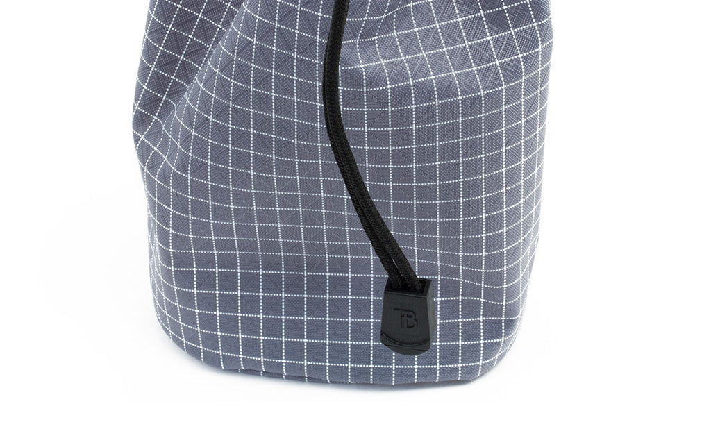 detail visible^^A close shot of the pull tab at the end of the drawstring on a Travel Stuff Sack.
