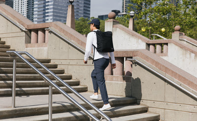 lifestyle visible^^Person carrying the Cambiata up some stares using the backpack straps.