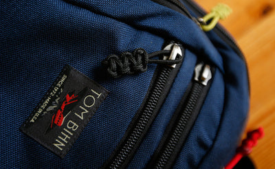 visible variant TB0512C-BA^^Cord Zipper Pulls knotted and attached to a bag's zipper sliders directly