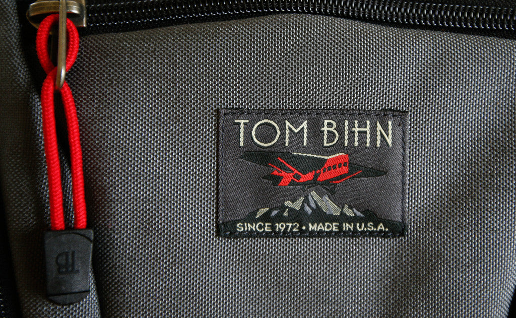 visible variant TB0512A-IA^^Cord Zipper Pulls with plastic pull tabs attached to a bag's metal zipper tabs