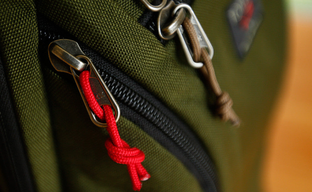 visible variant TB0512B-IA TB0512B-CA TB0512C-IA TB0512C-CA^^Cord Zipper Pulls knotted and attached to a bag's metal pull tabs.