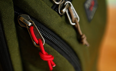 visible variant TB0512B-IA TB0512B-CA TB0512C-IA TB0512C-CA^^Cord Zipper Pulls knotted and attached to a bag's metal pull tabs.