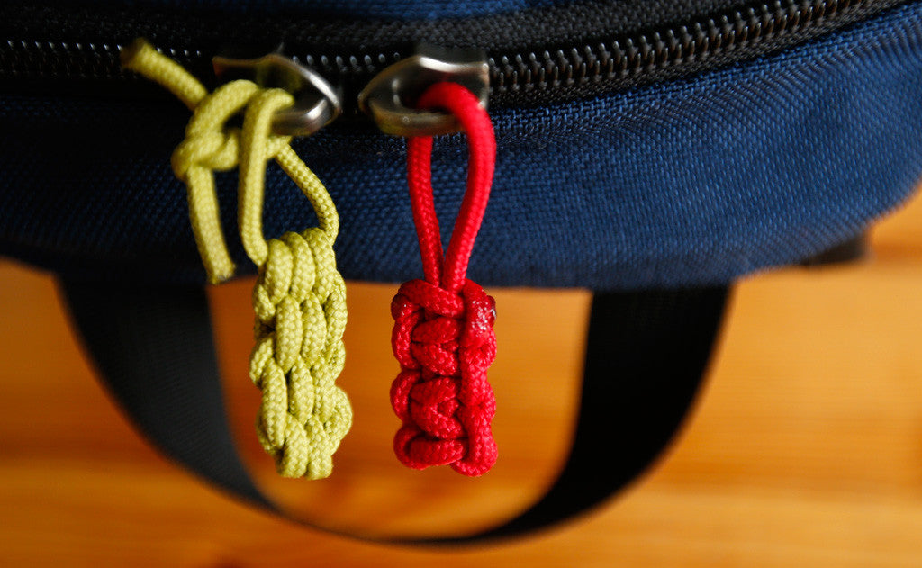 visible variant TB0512C-WA TB0512C-IA^^Cord Zipper Pulls knotted and attached to a bag's zipper sliders directly