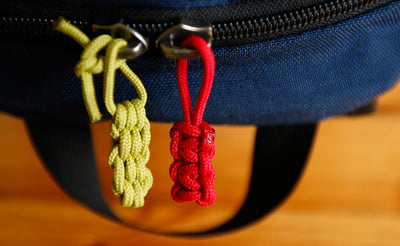 visible variant TB0512C-WA TB0512C-IA^^Cord Zipper Pulls knotted and attached to a bag's zipper sliders directly