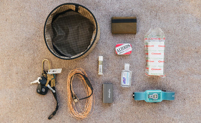 lifestyle visible^^A Large Travel Tray with a possible loadout (a minimalist wallet, a tin of Altoids, a watchband, a roll of twine, a portable charger and charge cable, hand sanitizer, a pair of keys, nail polish, and facial tissues)