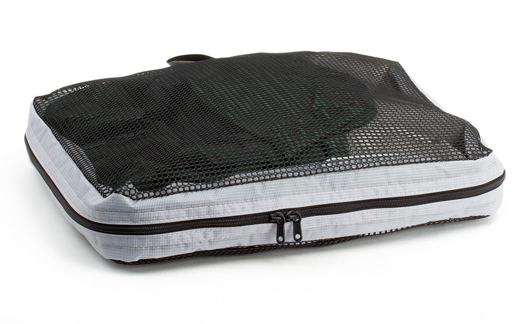 visible variant TB94002-NE^^A full, closed Medium Tri-Star Packing Cube in Northwest Sky (light grey) 120 Aether.