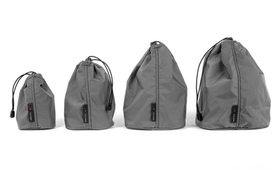 detail visible^^Sizes 1 through 4 of the Travel Stuff Sack in a row smallest to largest.