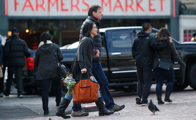 lifestyle visible^^A person carrying a full Moveable Feast at Pike Place Market.