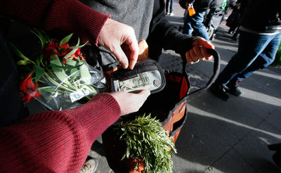 lifestyle visible^^A person holding a Moveable Feast while accessing a Clear Organizer Wallet.