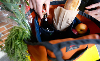 lifestyle visible^^A person pulling a beer out of a full Moveable Feast.