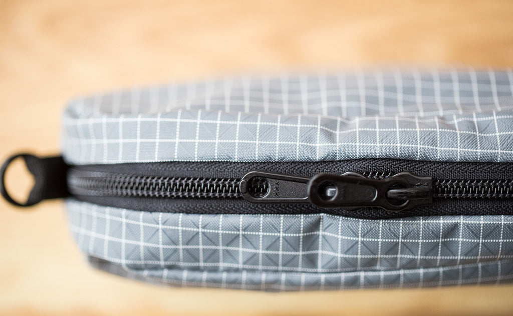 lifestyle visible^^A close-up shot of the zipper on the 3D Organizer Cube showing one of the exterior o-rings.