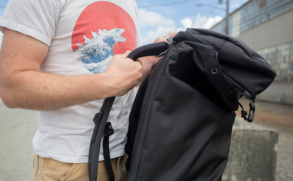 visible lifestyle^^Nik grasps the Edgeless Shoulder Straps of the Shadow Guide to show off how cushioned they are.