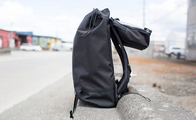 lifestyle visible^^Side view of the Shadow Guide 33; the top pocket is hanging back over the backpack straps.