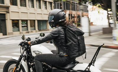 lifestyle visible^^Woman wearing the Shadow Guide 33 while riding her Harley Davidson motorcycle in a downtown city area.