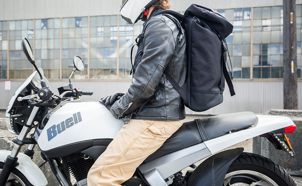 lifestyle visible^^Nik on his Buell Blast motorcycle, helmet and leather jacket on, wearing the Shadow Guide 33 backpack.