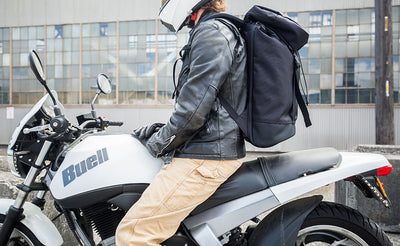 lifestyle visible^^Nik on his Buell Blast motorcycle, helmet and leather jacket on, wearing the Shadow Guide 33 backpack.