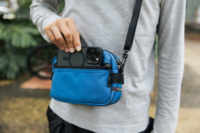 lifestyle visible^^Person taking a phone from the front pocket of the Side Effect.