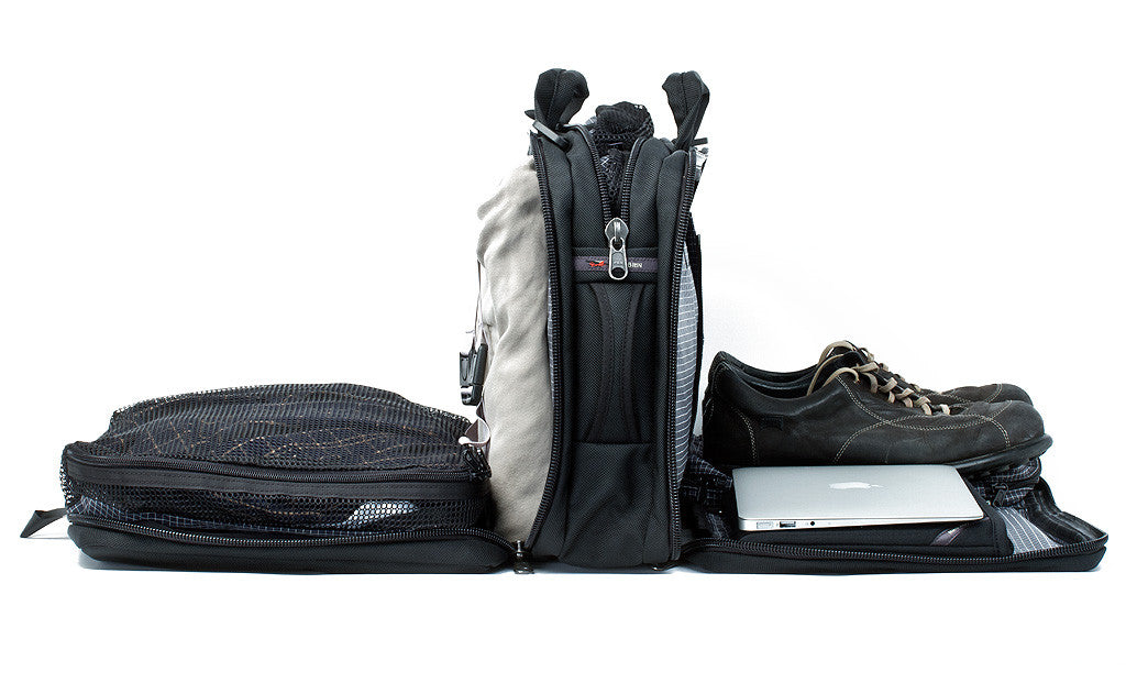 detail visible^^A Tri-Star with each of its main pockets filled with, from front to back, a pair of shoes and tablet in the front divided compartment, a packing cube in the middel pocket, and a packing cube and jacket in the rear main pocket.