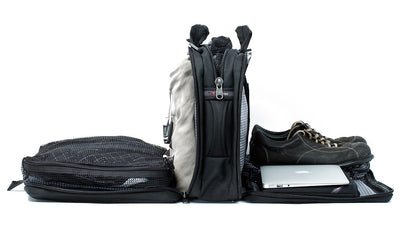 detail visible^^A Tri-Star with each of its main pockets filled with, from front to back, a pair of shoes and tablet in the front divided compartment, a packing cube in the middel pocket, and a packing cube and jacket in the rear main pocket.