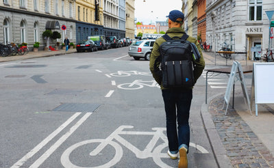 lifestyle visible^^A person walking down a street wearing a Tri-Star via the included backpack straps.