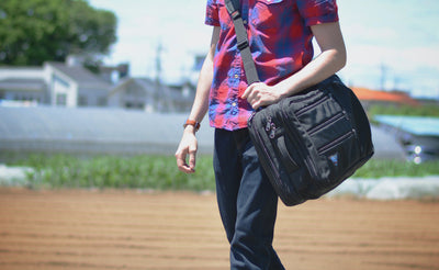 lifestyle visible^^A person carrying a Tri-Star via the optional Absolute Shoulder Strap.