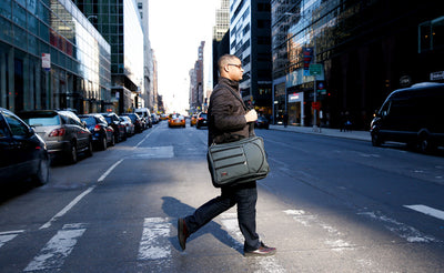 lifestyle visible^^A person carrying a Tri-Star across a crosswalk using the optional Absolute Shoulder Strap.