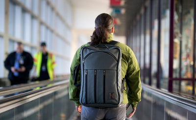 lifestyle visible^^A person on a moving sidewalk at an airport wearing a Tri-Star via the included backpack straps.