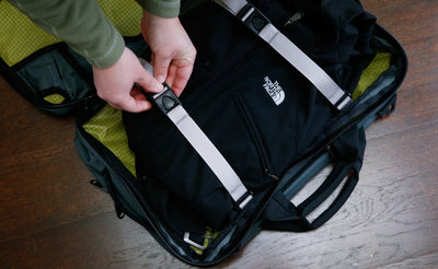 detail visible^^A top-down shot of the luggage straps in the rear main compartment of a Tri-Star being used to hold a jacket in place.