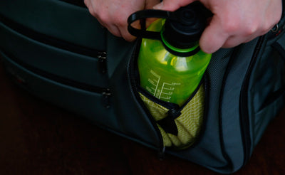 detail visible^^A 16 ounce water bottle being removed from the water bottle pouch on a Tri-Star.