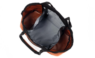 visible variant TB0619-TKND^^The Truckasana in Burnt Orange with Northwest Sky 200d Halcyon lining. Top-down photo shows the empty three main compartments of the bag.