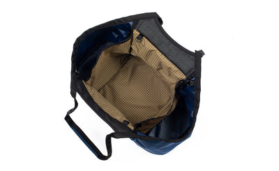 visible variant TB0619-DKCD^^Truckasana in Deep Blue/Coyote tan. Top-down view shows the empty three main compartments of the bag.
