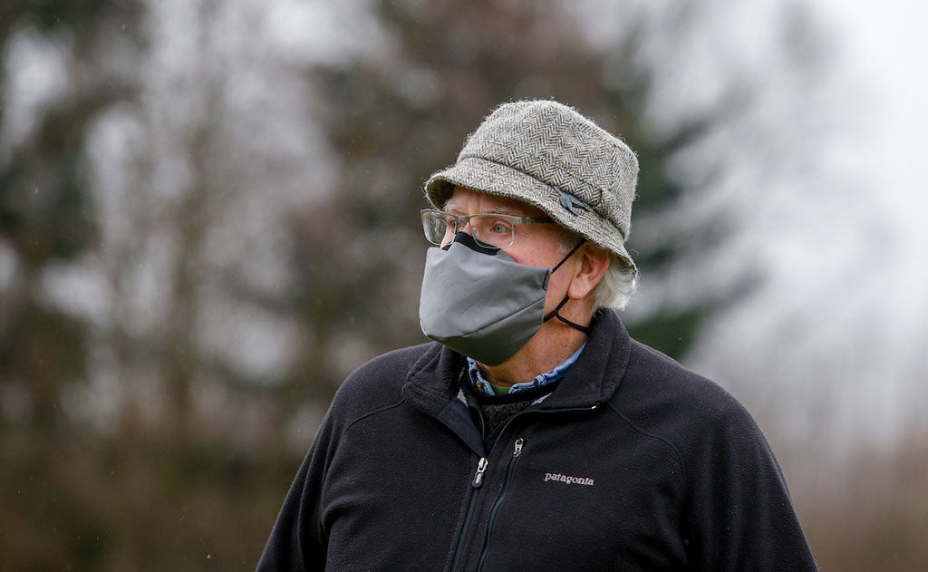 visible variant ME00013-GO^^Person wearing the V6 Mask in True Grey outdoors. The person is wearing a fleece jacket, hat, and glasses.