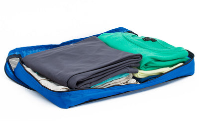 visible variant TB95204-LE^^An open Large Western Flyer Packing Cube in Island (blue) 120 Aether filled with shirts and pants.