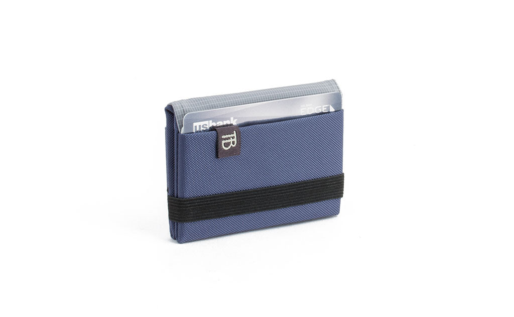 visible variant TB1277-DJ^^The Size 1 Nik's Minimalist Wallet in Dawn (blue-grey) 210 Ballistic closed pockets-out with the attached elastic band.