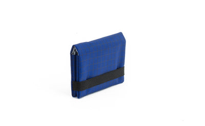 visible variant TB1277-DH^^The Size 1 Nik's Minimalist Wallet in Nordic (blue with grey grid) 400 Halcyon closed with the attached elastic band.