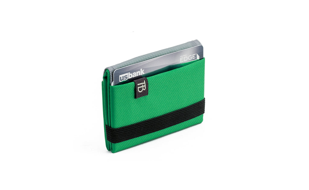 visible variant TB1277-GJ^^The Size 1 Nik's Minimalist Wallet in Grass (bright green) 210 Ballistic closed pockets-out with the attached elastic band.