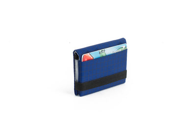 visible variant TB1279-DH^^The Size 3 Nik's Minimalist Wallet in Nordic (blue with grey grid) 400 Halcyon closed with the attached elastic band.